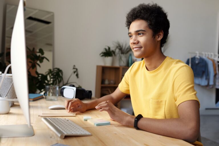 High school student learning at desk with computer